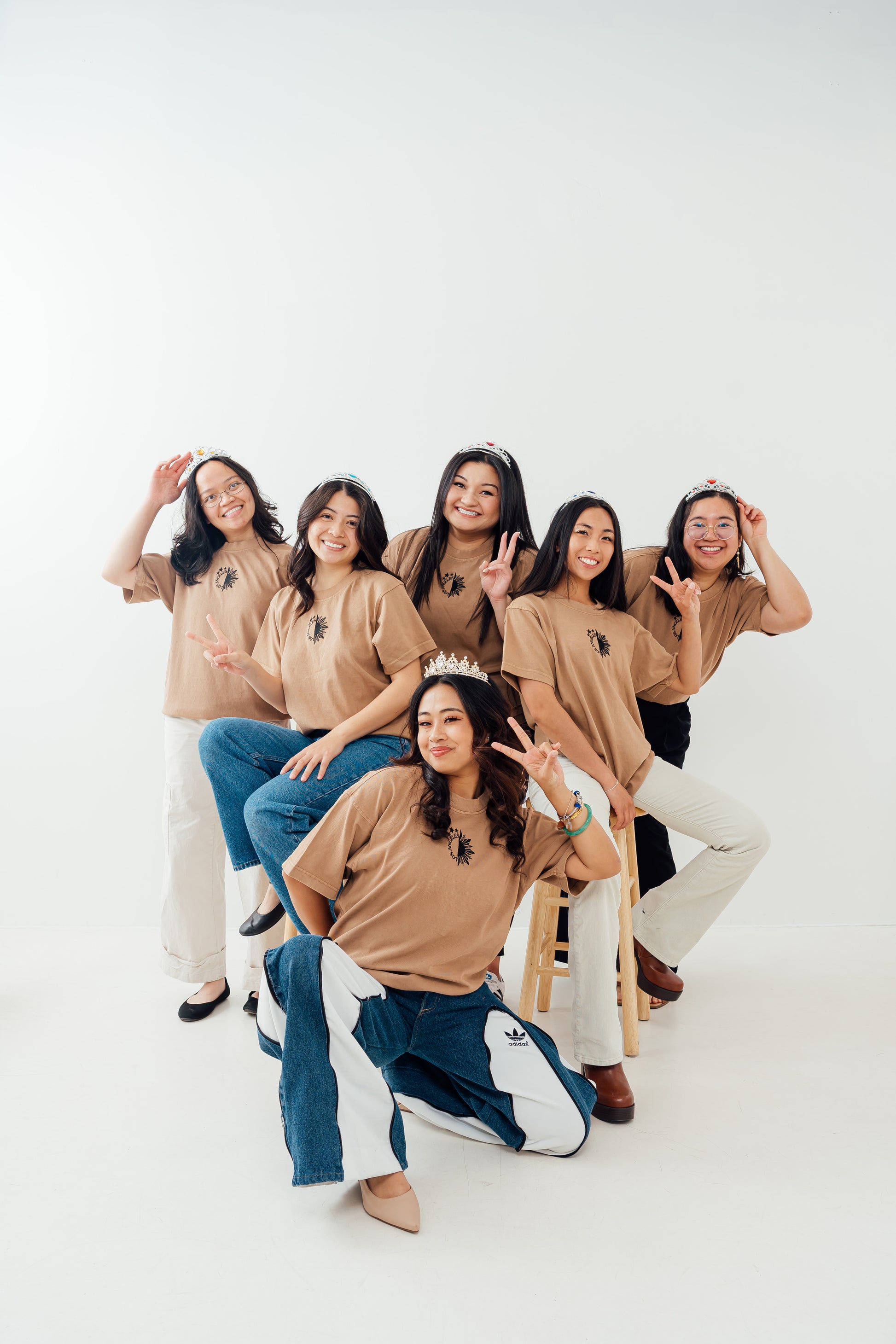 Group of six women posing together wearing LA Essentials Tee