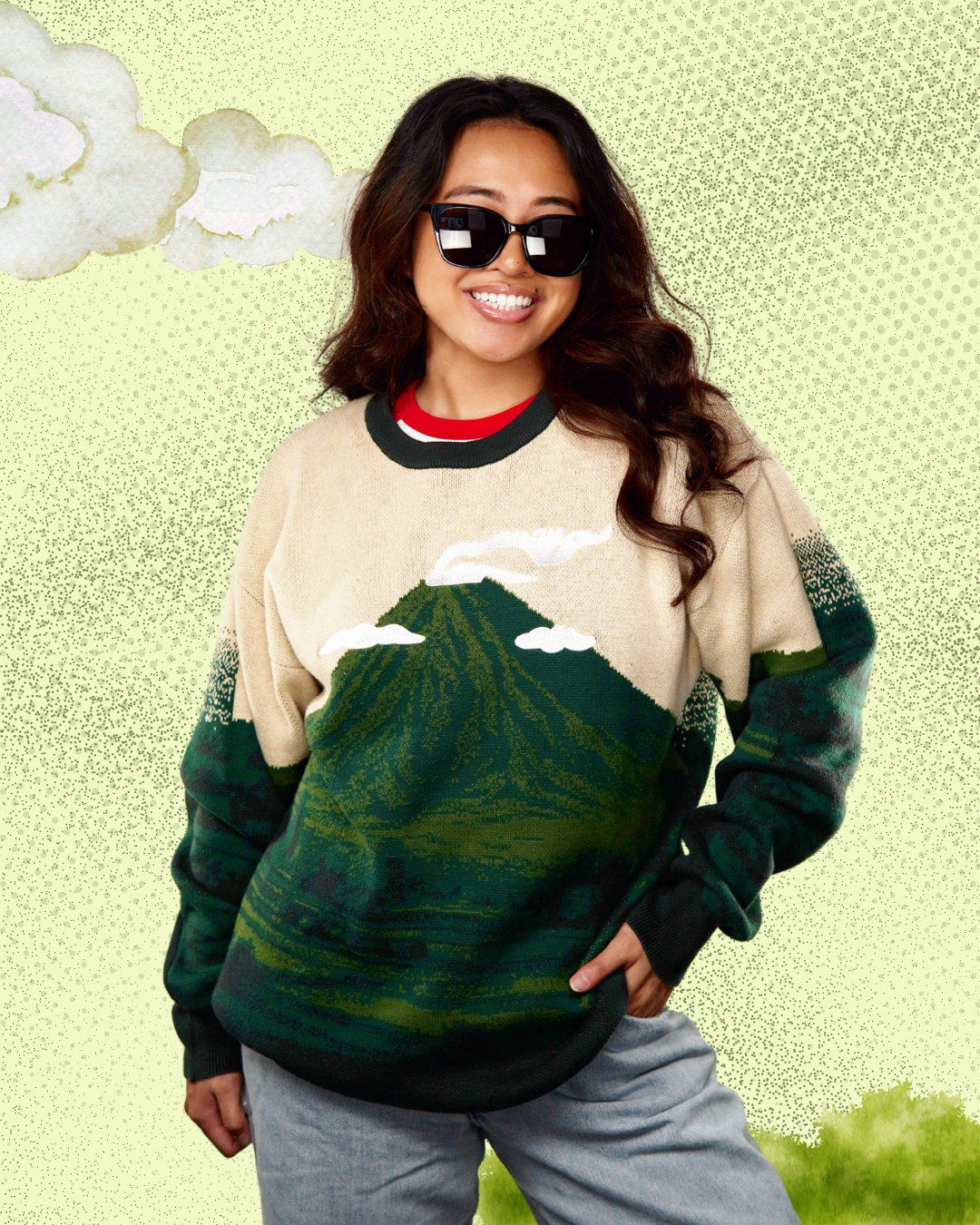Person wearing a sweater with a mountain design on a light green background