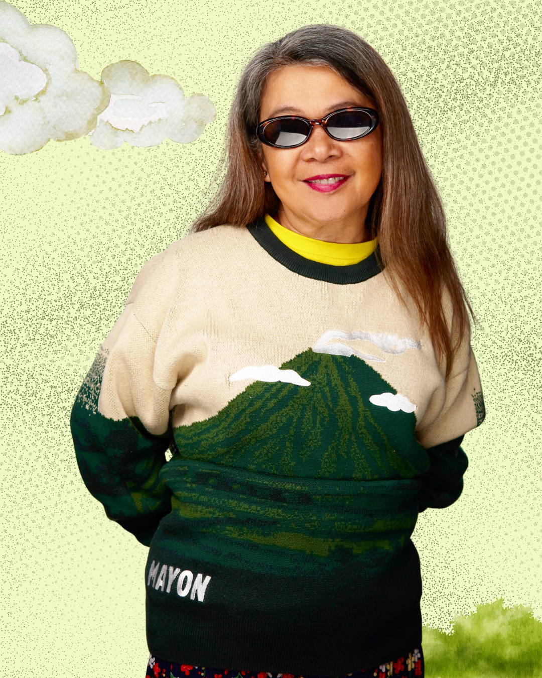 Person wearing a sweater with a mountain design on a light green background