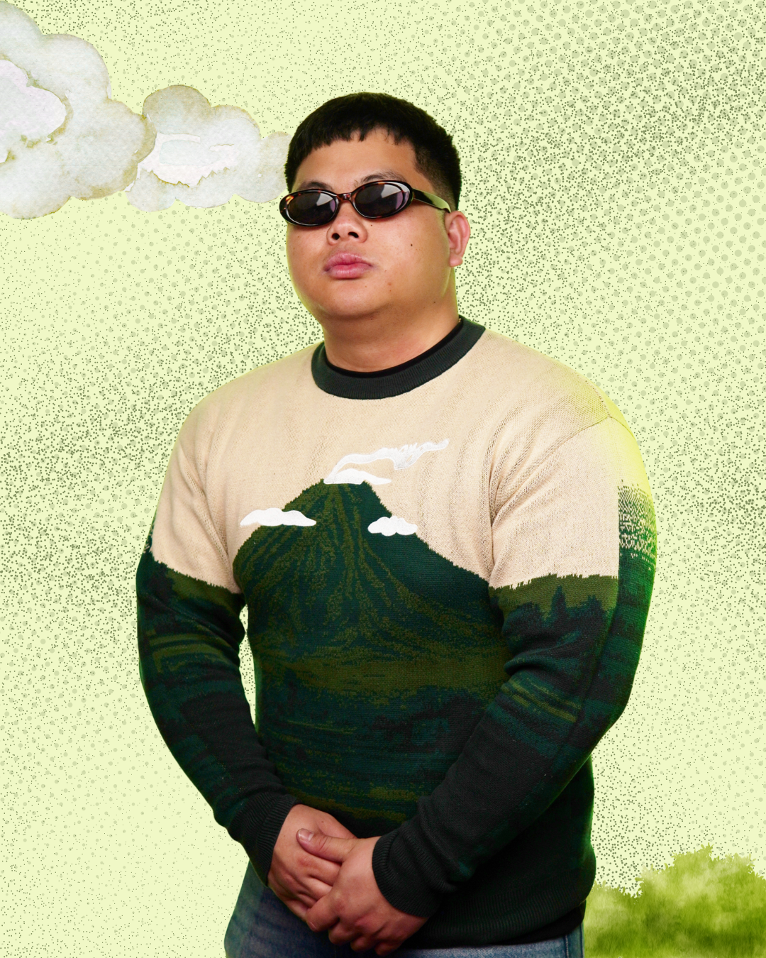 Person wearing a sweater with mountain and cloud design on a light green background