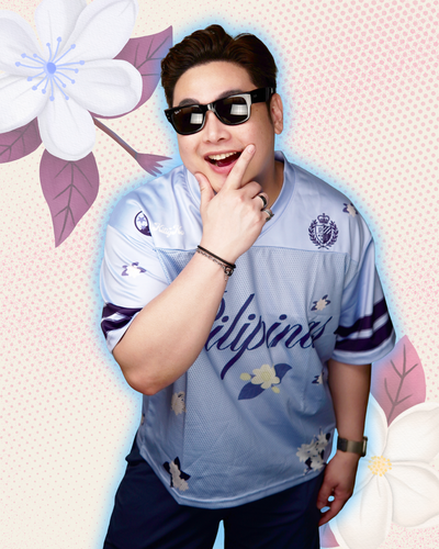 Model wearing blue football jersey with 'pilipinas' in cursive text and sampaguita flower prints all over