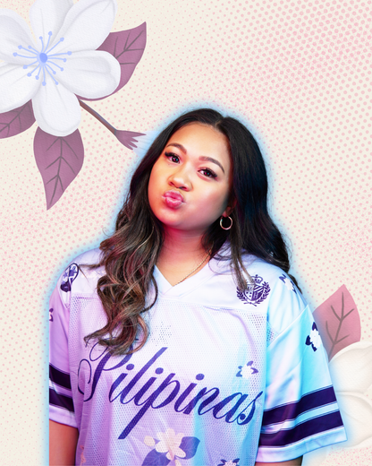 Model wearing blue football jersey with 'pilipinas' in cursive text and sampaguita flower prints all over