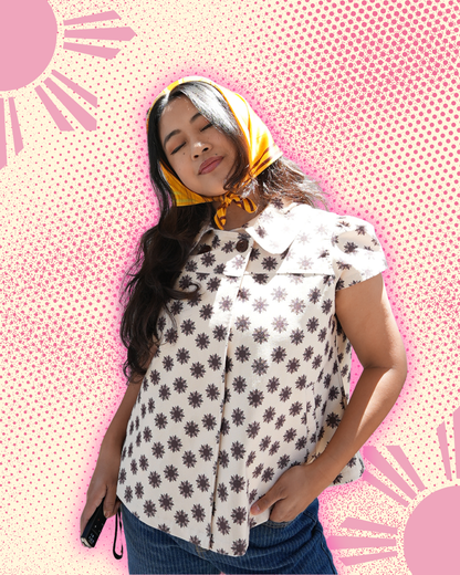 Model wearing sun patterned blouse in black and white